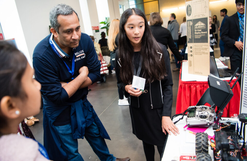 A middle school student explains their research project during the Society for Science middle school STEM competition