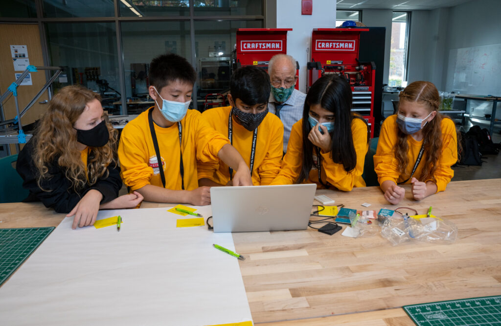 The gold team brainstorms a device to detect Parkinson's disease tremors at George Mason University during 2022 Broadcom MASTERS finals week.