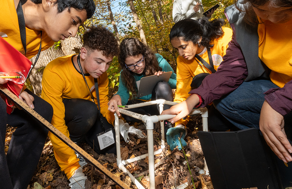 The 2024 JIC Gold team gathers around their biocube