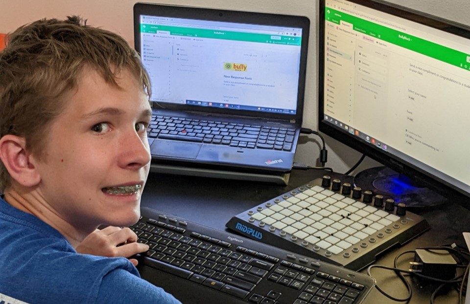 Nathan Fellars smiling at his computer setup