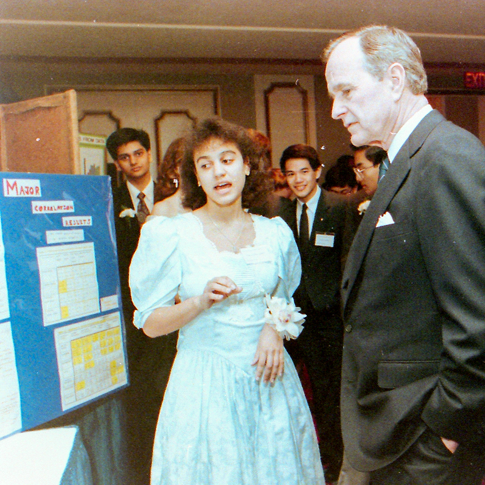 STS finalist Tara Bahna-James explains her research to President George H. W. Bush
