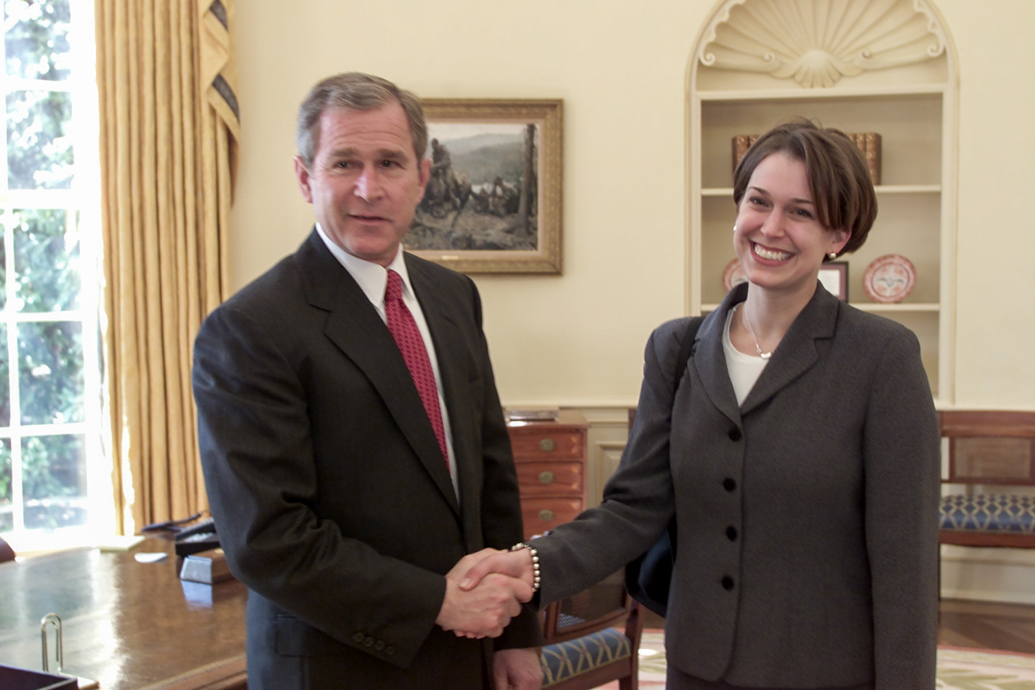 President George W. Bush shakes hands with Tzeitel Fetter Hirni