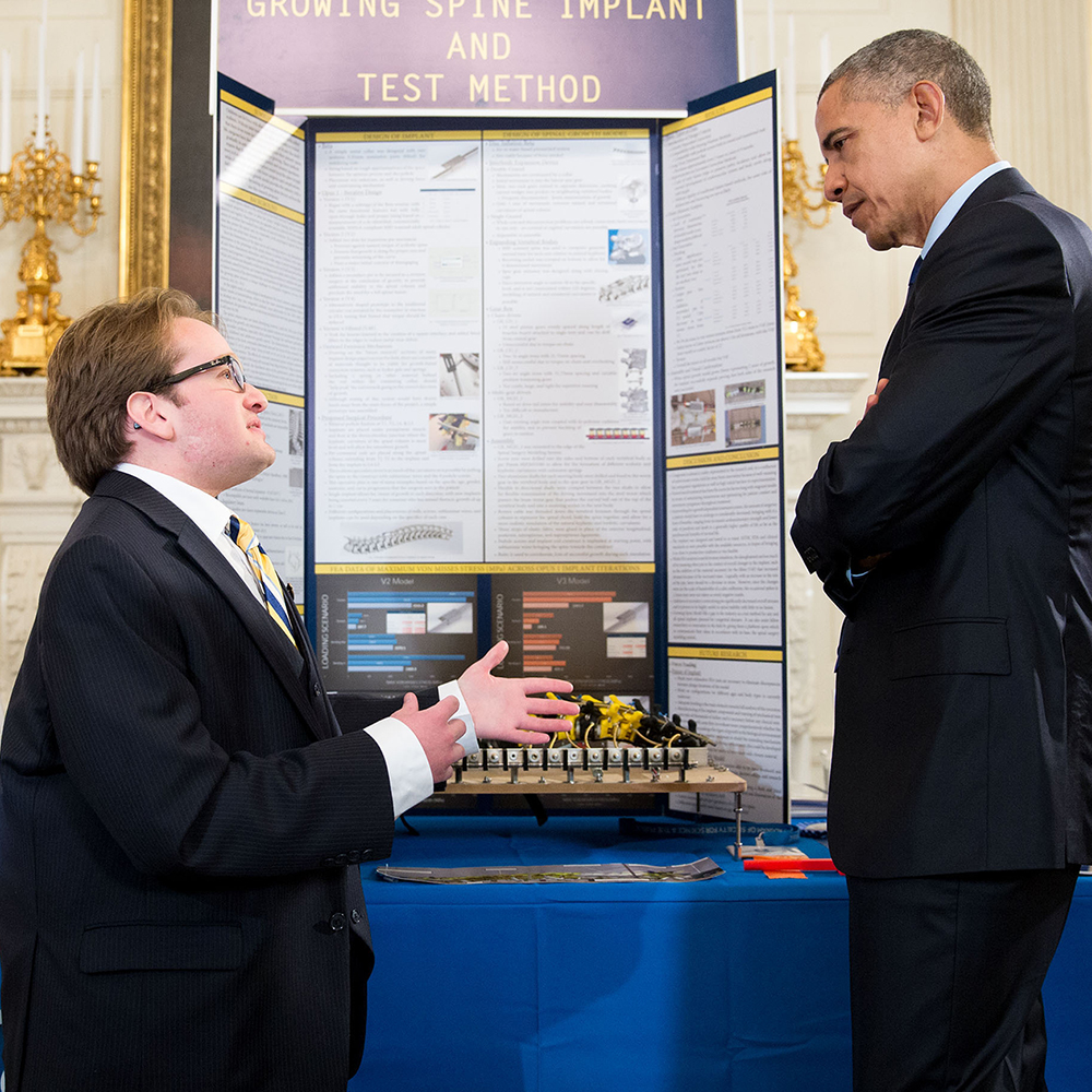 President Obama listens to Harry Paul discuss His project