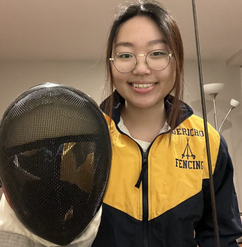 2023 Regeneron STS Finalist Emily Kim holding her fencing gear.