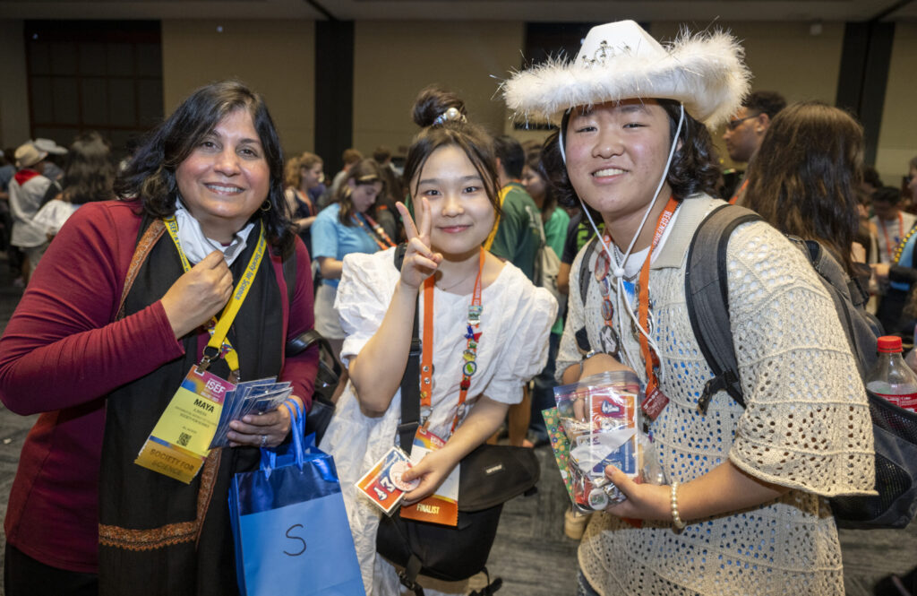 Society for Science President and CEO of Society for Science, and Executive Publisher of Science News Maya Ajmera (left) poses for a photo with 2023 Regeneron ISEF finalists during the Pin Exchange.
