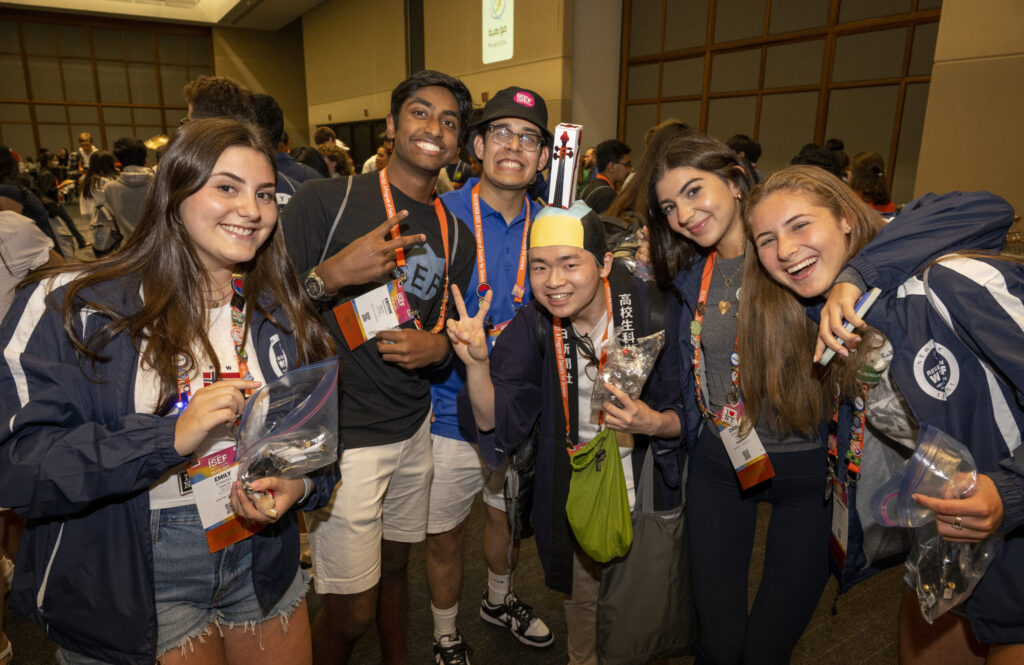 2023 Regeneron ISEF finalists pose for a photo together at the pin exchange, bringing together different cultures.