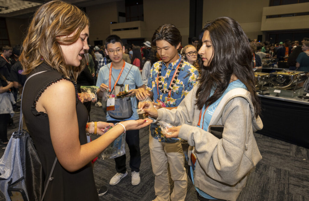 2023 Regeneron ISEF finalists exchanging pins during the pin exchange to kick off competition week.