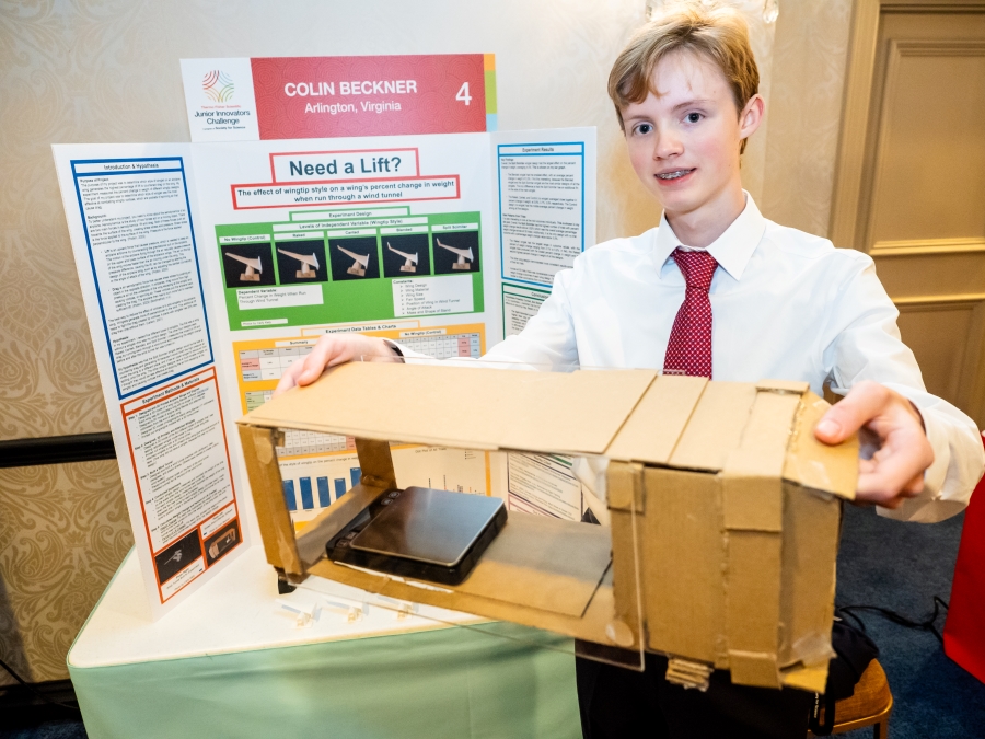 Colin Beckner standing at his project poster