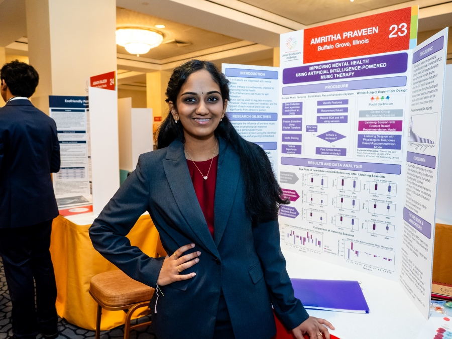 Amritha Praveen standing at her project poster