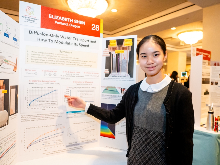 Elizabeth Shen standing at her project poster