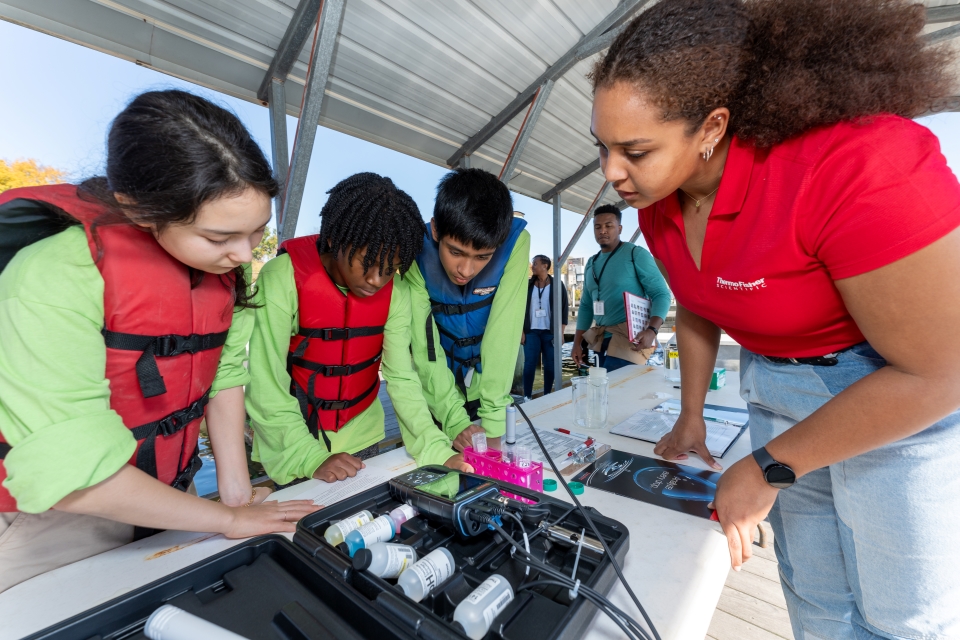 The Green team receives instruction from Thermo Fisher scientists on how to test water quality