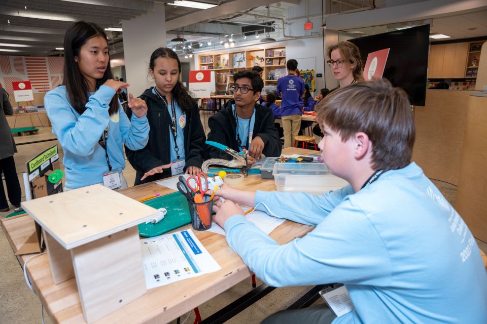 The blue team figures out how best to build their minigolf course.