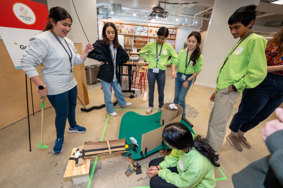 Finalists try out the green team's minigolf course.