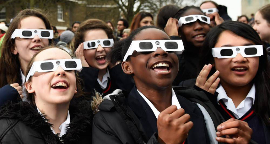 Students keep their eyes safe with certified glasses when looking up at the sun. American Paper Optics