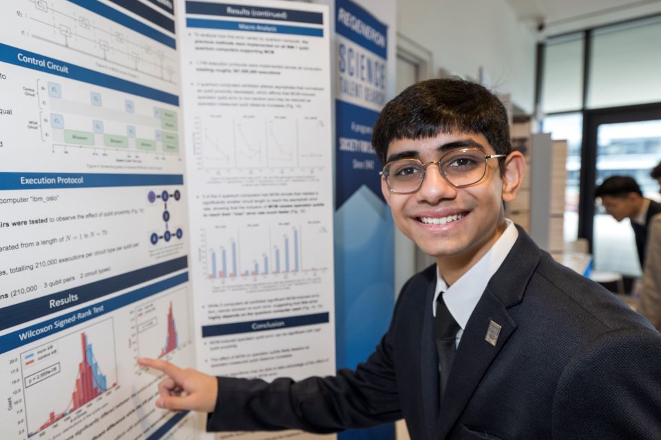 Harshil Avlani poses at his board during the Public Exhibition of Projects