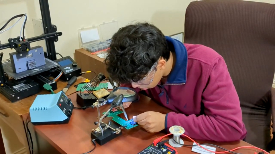 Sarang Goel soldering his project