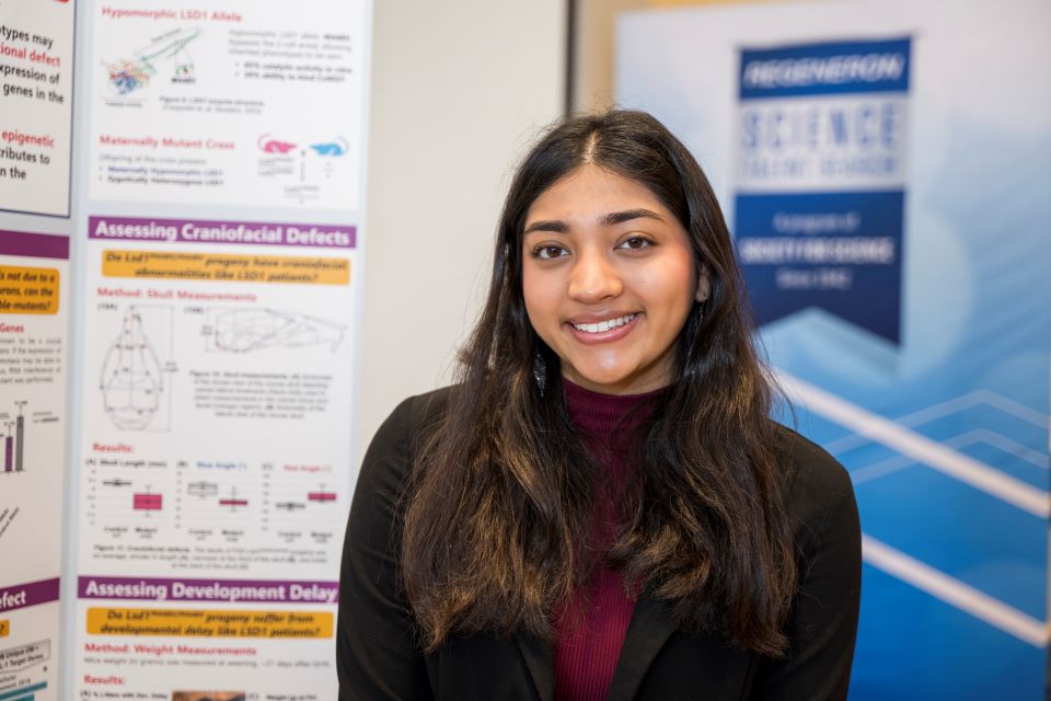 Rhea Rastogi stands by her project board at the Public Exhibition of Projects.