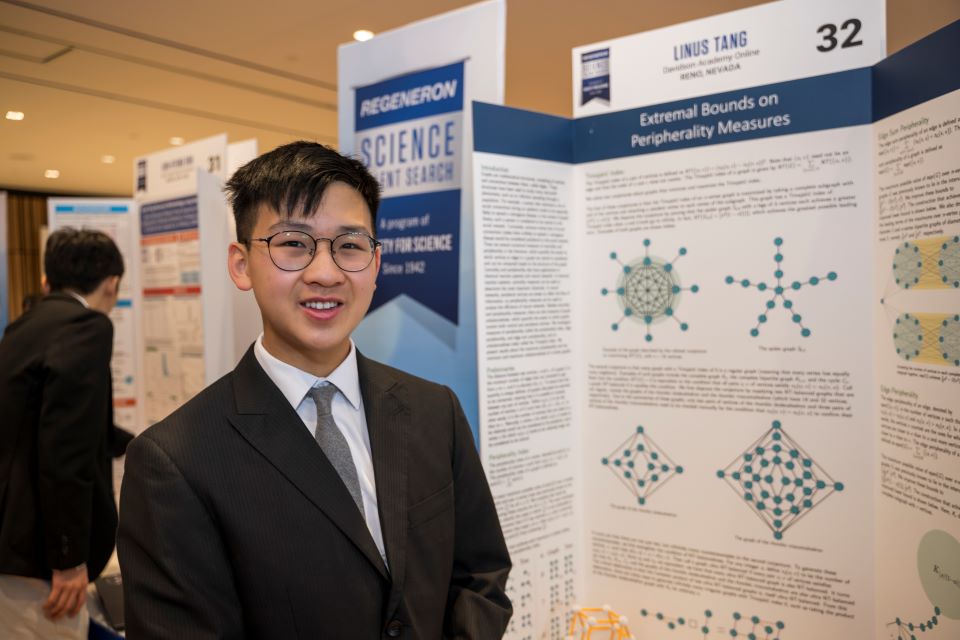 Linus Tang stands by his poster at the Public Exhibition of Projects.