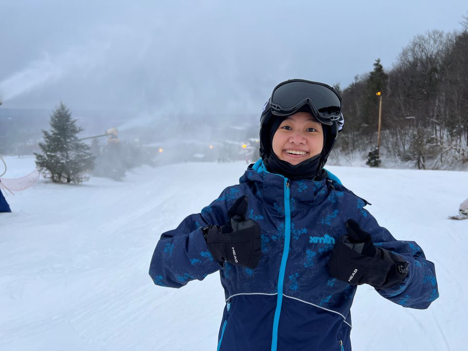 Selina Zhang, inventor of an artificial tree which kills invasive spotted lanternflies, poses on a ski slope.