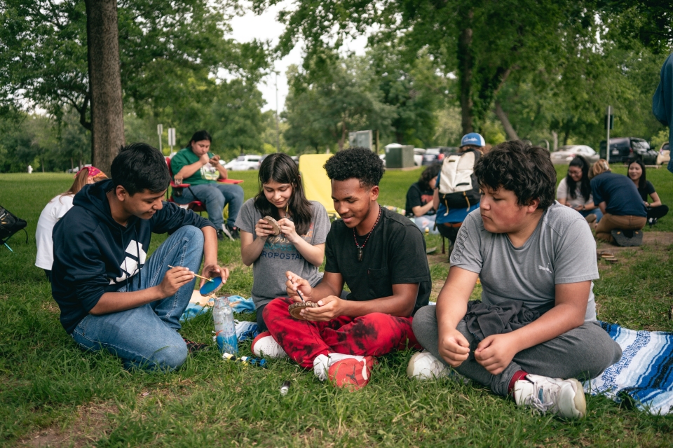 River Watchers sitting together on the grass