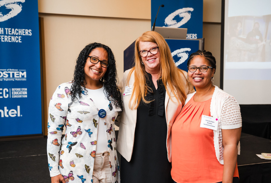 Three women (Yajaira Torres-De Jesús, Jill Hansen, and Yolanda Payne) pose for a photo at the Research Teachers Conference.