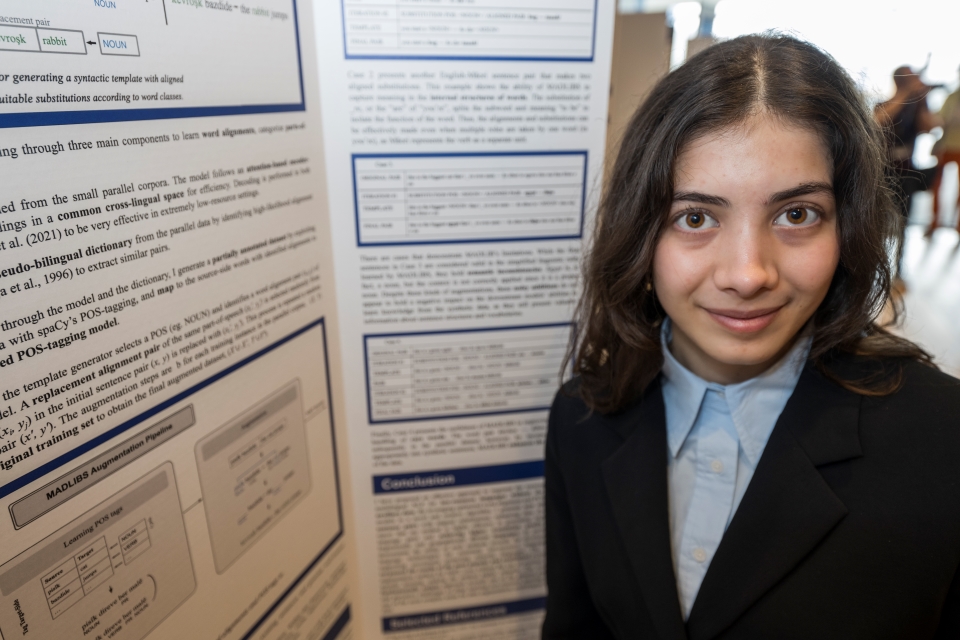 Zeyneb Kaya standing at her project board