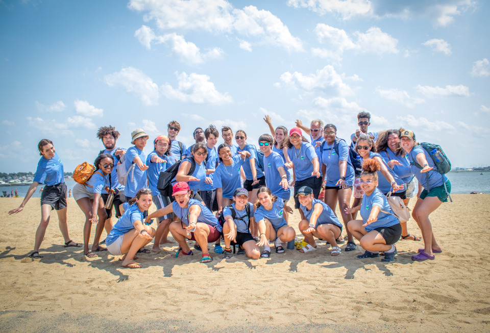 A group shot of program participants on the beach
