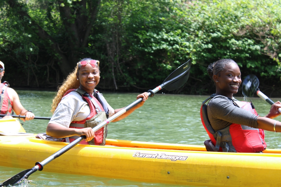 Youth riding in a kayak as part of Venture Outdoors' programming.