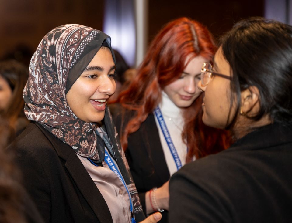 Three finalists chat during a reception following the alumni dinner.