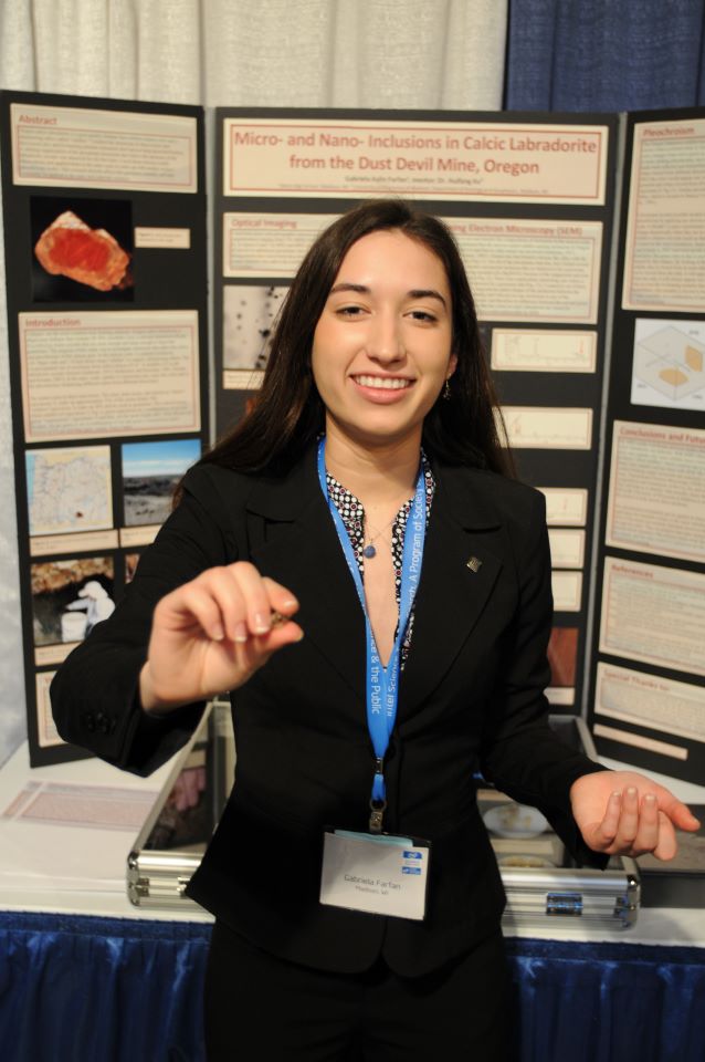 Gabriela stands at her project board during STS 2009