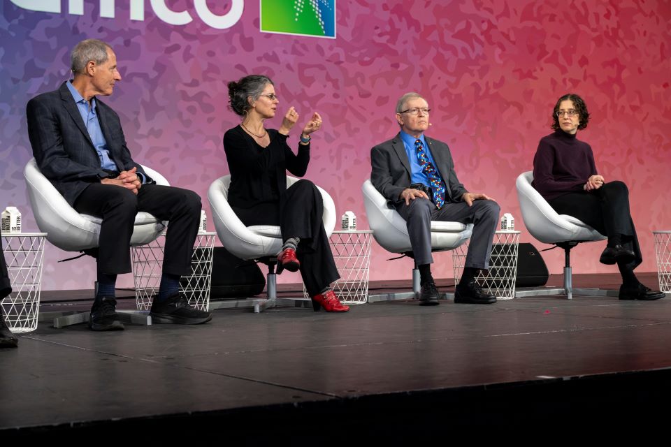 From the left: Thomas Rosenbaum, Dianne Newman, W.E. Moerner and Elissa Hallem sit on a stage at Regeneron ISEF.