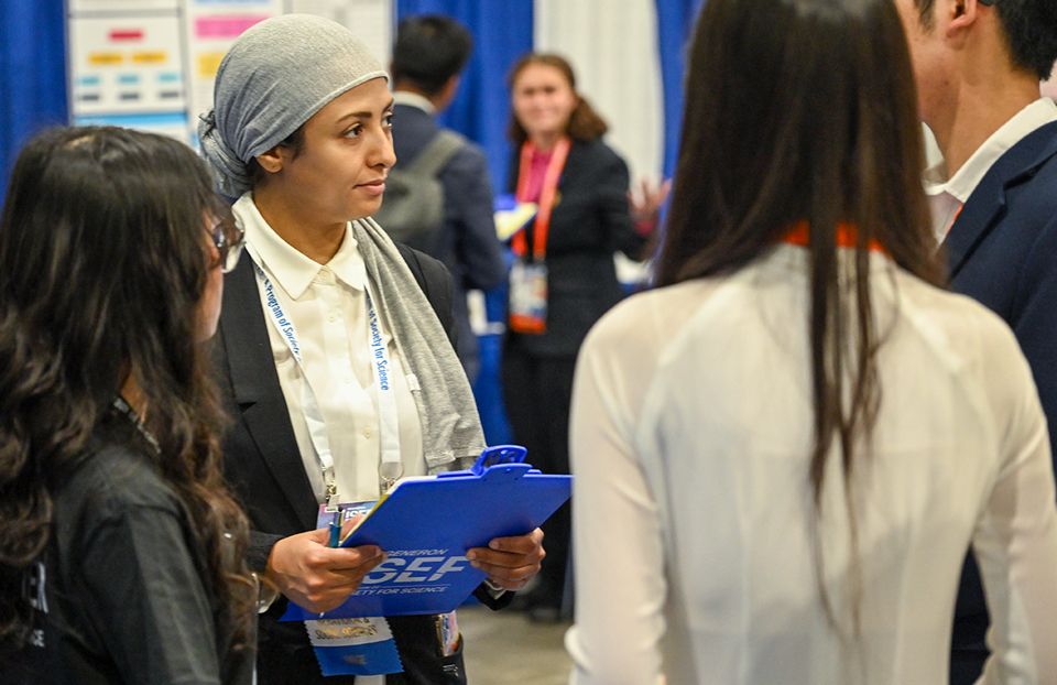 ISEF 2024 - International Science and Engineering Fair - Judging - finalists at booth with judges - Los Angeles CA