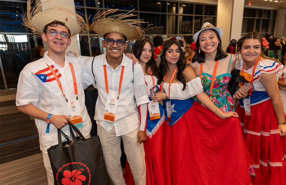Group of finalists wearing traditional attire at the pin exchange.