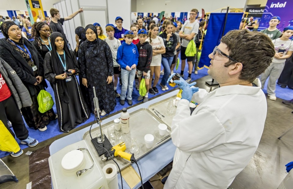 A scientist leads a demonstration for a group of students