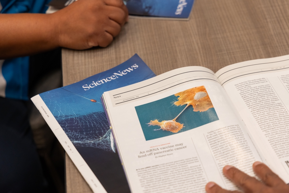 Open issues of Science News being read at a table