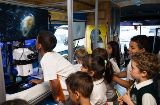 Students enjoy working with a microscope on the BioBus.