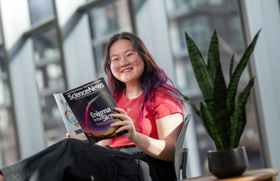 Regeneron STS 2024 finalist Sophie Gao reading an issue of Science News.