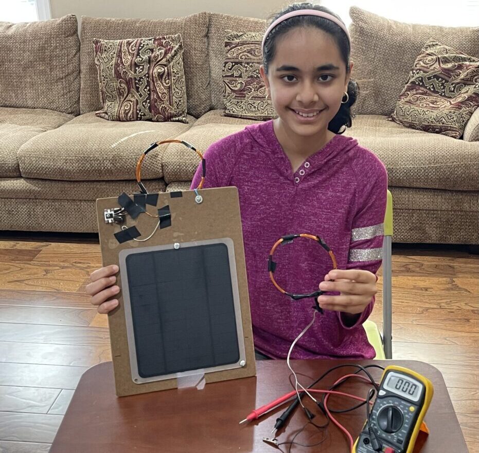 Shriya Tailor holding her invention's prototype.