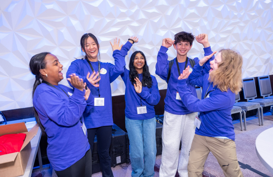 The 2024 Thermo Fisher JIC purple team finalists cheering.