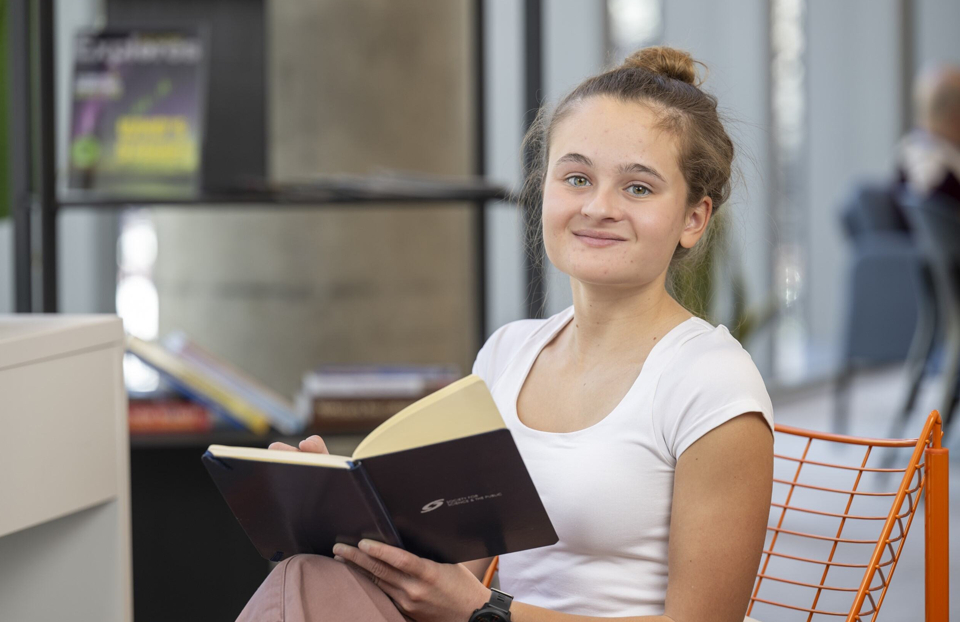 Regeneron STS 2025 finalist Addison Shea reading a notebook.