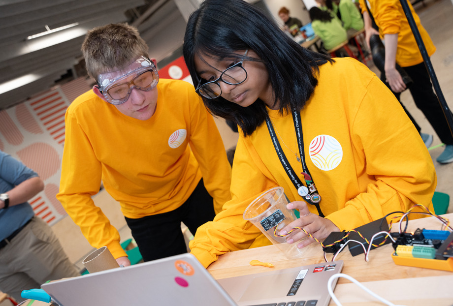 Two Thermo Fisher JIC finalists looking at a laptop during a challenge.