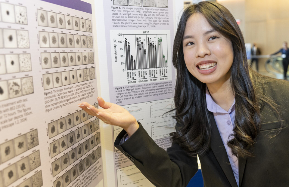 Regeneron STS 2025 finalist Emma Wen in front of her project board.