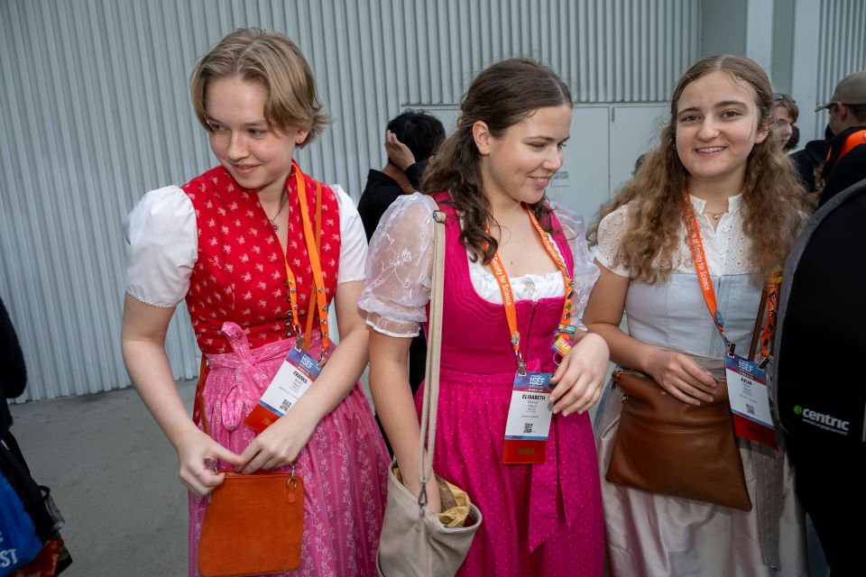 2024 ISEF - Three members of Team Germany in dirndls hand out pins.