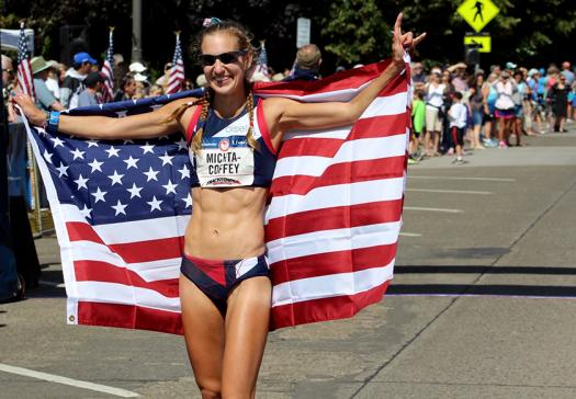 Maria holds up the American flag after winning Olympic Trials this summer.