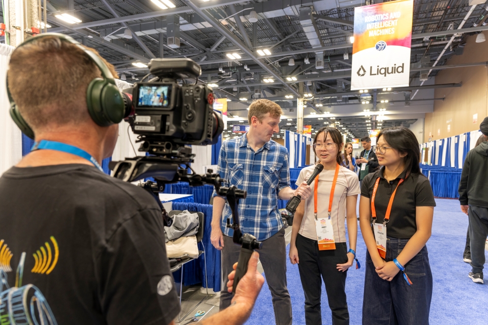 Kevin Easterly invterview two Regeneron ISEF finalists in front of a camera