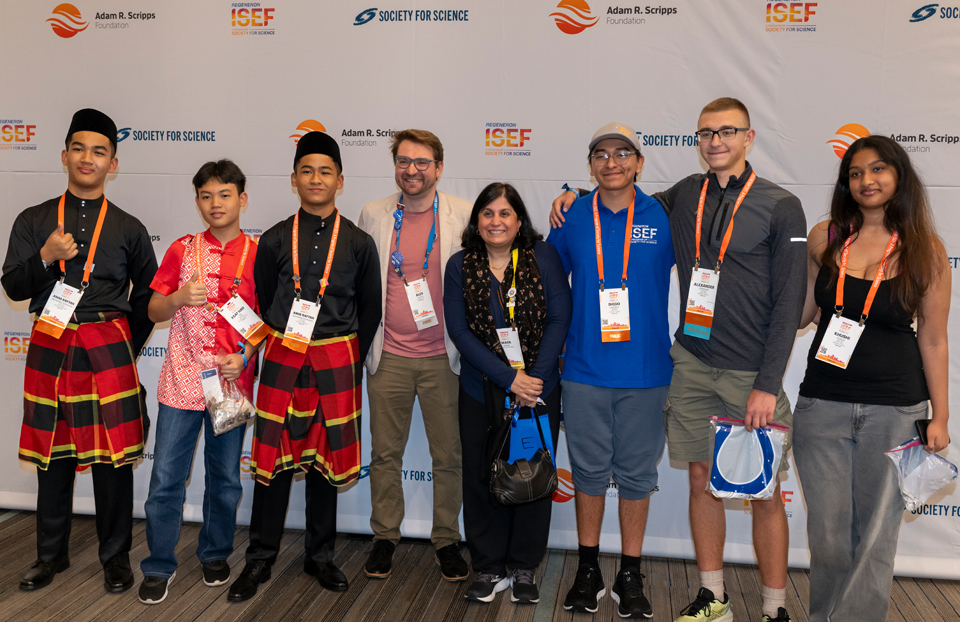 Group of 2025 ISEF finalists with Alex Bakkum, Chief Philanthropy Officer for the Adam Scripps Foundation and Maya Ajmera, President and CEO of Society for Science and Executive Publisher of Science News centered.