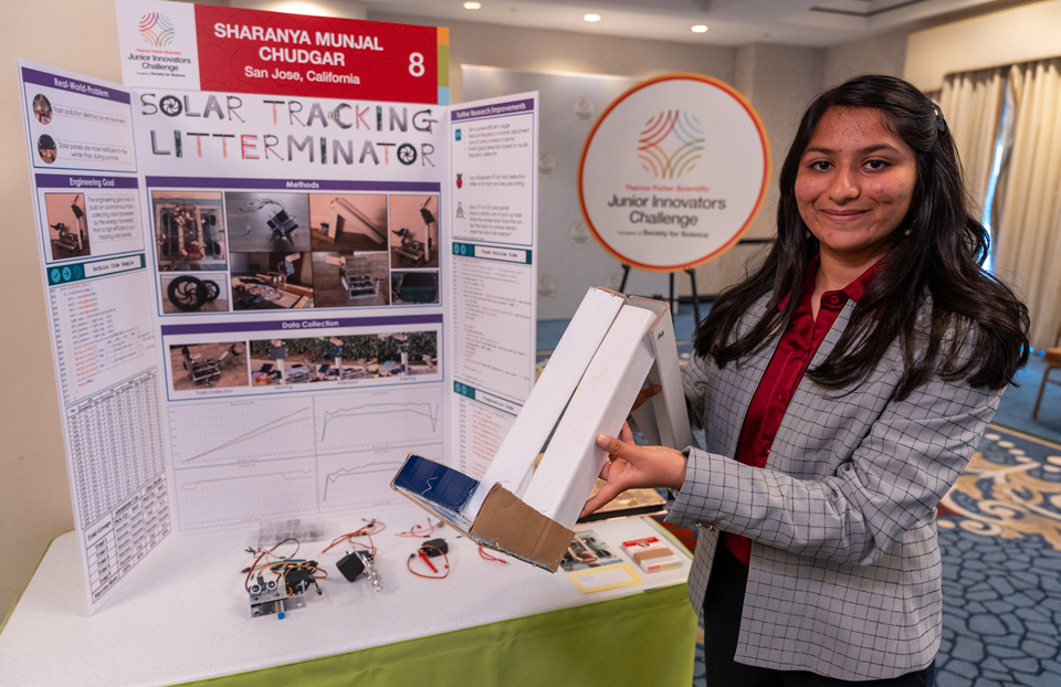 2023 JIC Finalist Sharanya Chudgar holding her solar tracking invention.