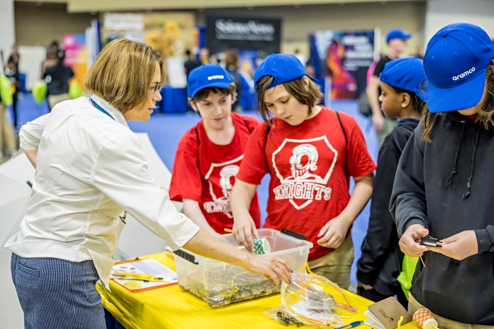 An exhibitor leads students in hands-on activities