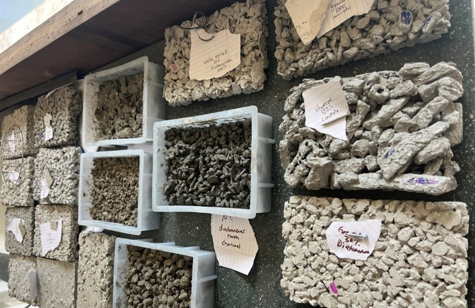 Testing materials of concrete and walk displayed in different bins.