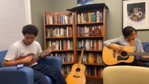 Ava Cummings (STS 2025) plays guitar at Yale's Native American Cultural Center.